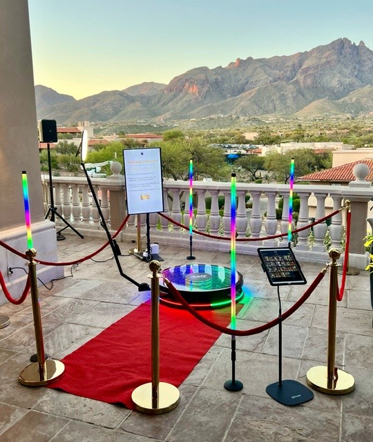 360 booth setup with LED light poles and red carpet at La Paloma resort patio, Catalina Mountains at sunset